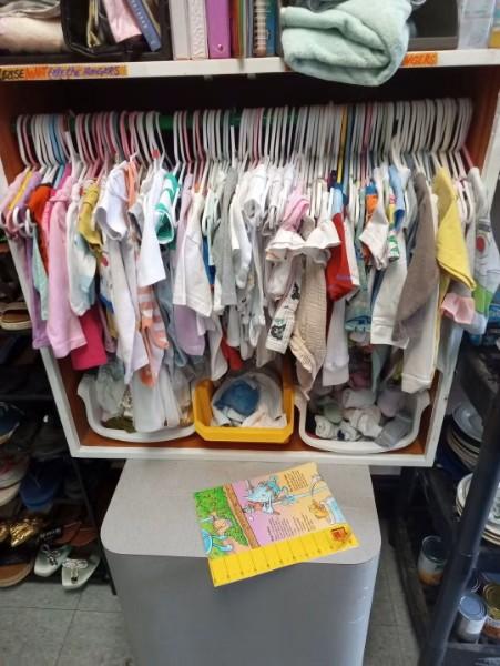 Baby clothing sorted on small hangers.