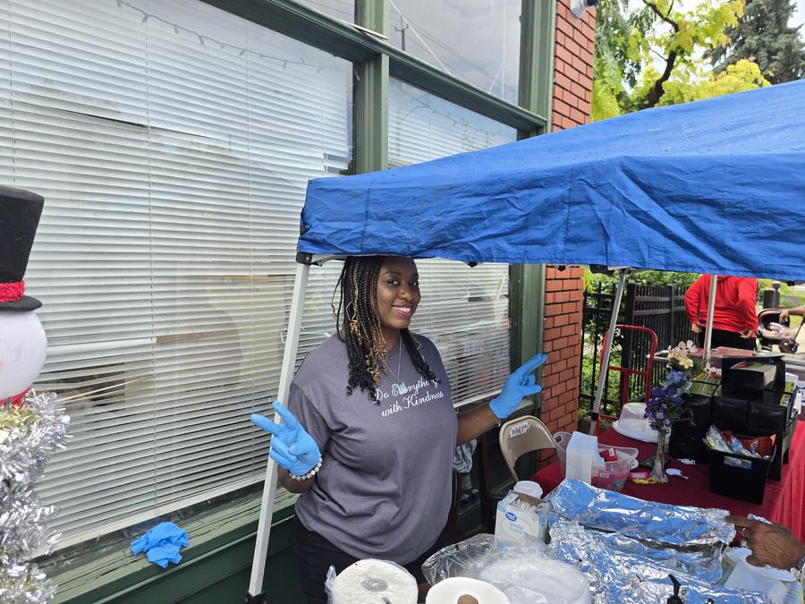A volunteer in a "Do Everything with Kindness" shirt at the relief drive.