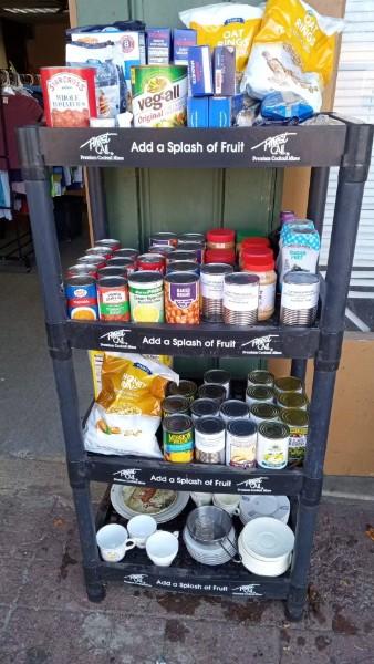 A shelf stocked with canned and boxed food items.